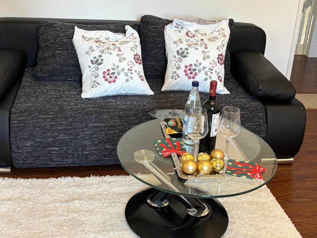a glass coffee table in front of a couch at Gästehaus in Kronshagen
