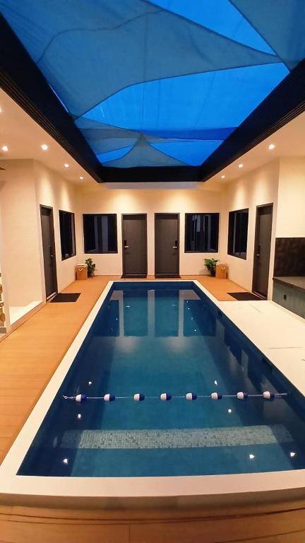 a large swimming pool with a blue ceiling at Oceara Dharavandhoo in Dharavandhoo