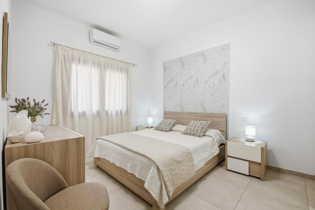 Ένα ή περισσότερα κρεβάτια σε δωμάτιο στο Figarolo apartment by Residence Moresca