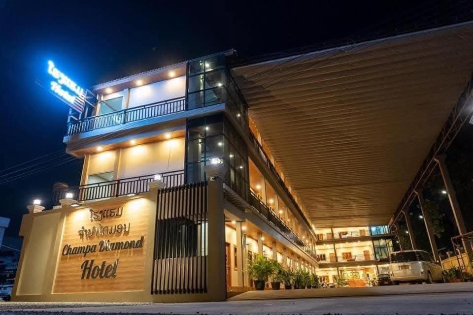 a building with a hotel at night at Champadiamon hotel in Pakse