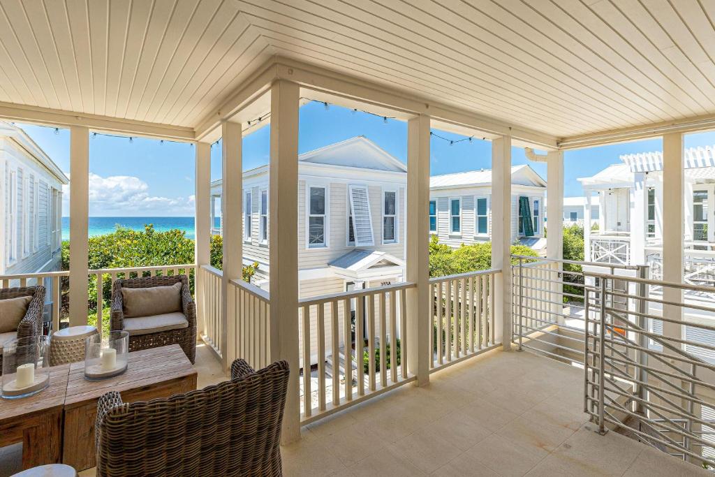 a screened in porch with a view of the ocean at On the Beach in Santa Rosa Beach