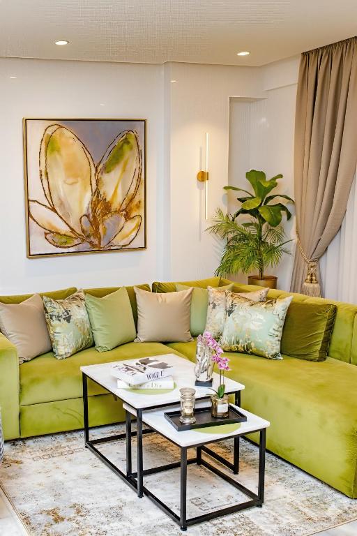 a living room with a yellow couch and a table at Family Aparthotel in Casablanca