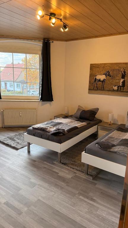a bedroom with two beds and a window at Fewo Monteurwohnung SAW II in Salzwedel