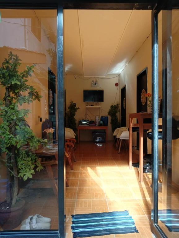 a living room with a table and a dining room at El Nido Cabugao Loudge in El Nido