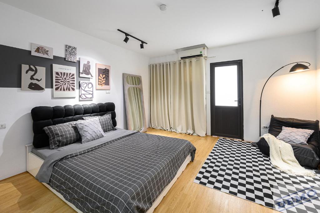 a bedroom with a bed and a checkered rug at Love Paradise Hotel Hà Nội in Hanoi