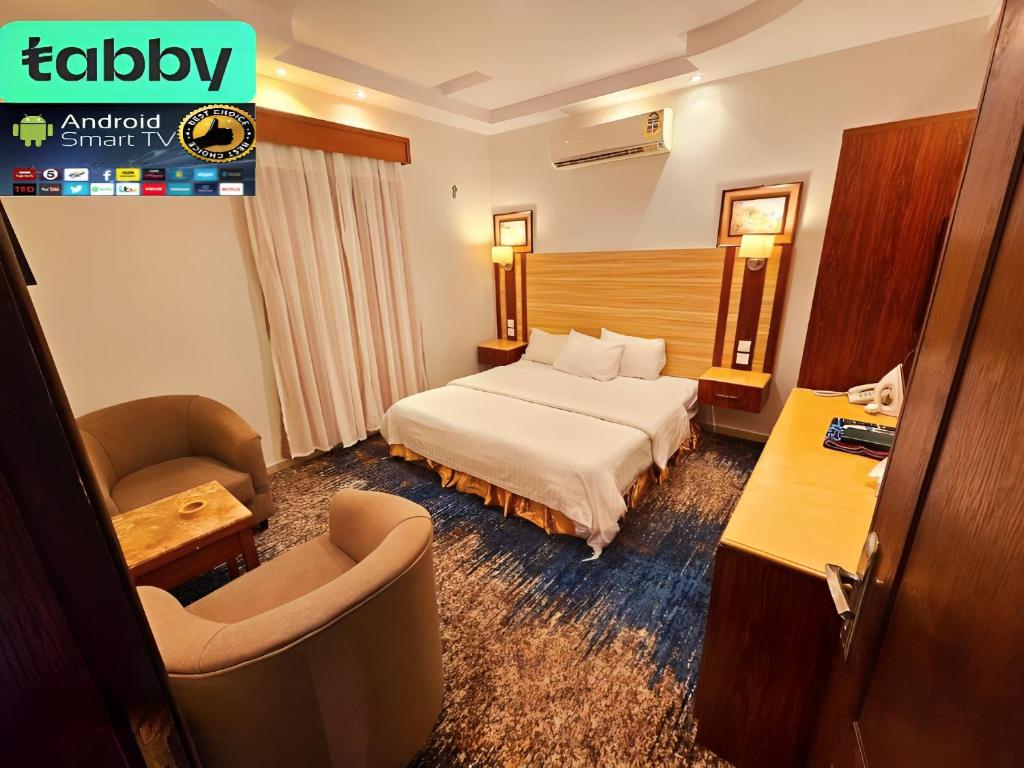a hotel room with a bed and a chair at قصر البسمة للشقق المخدومةSMILE Serviced Apartments in Jeddah