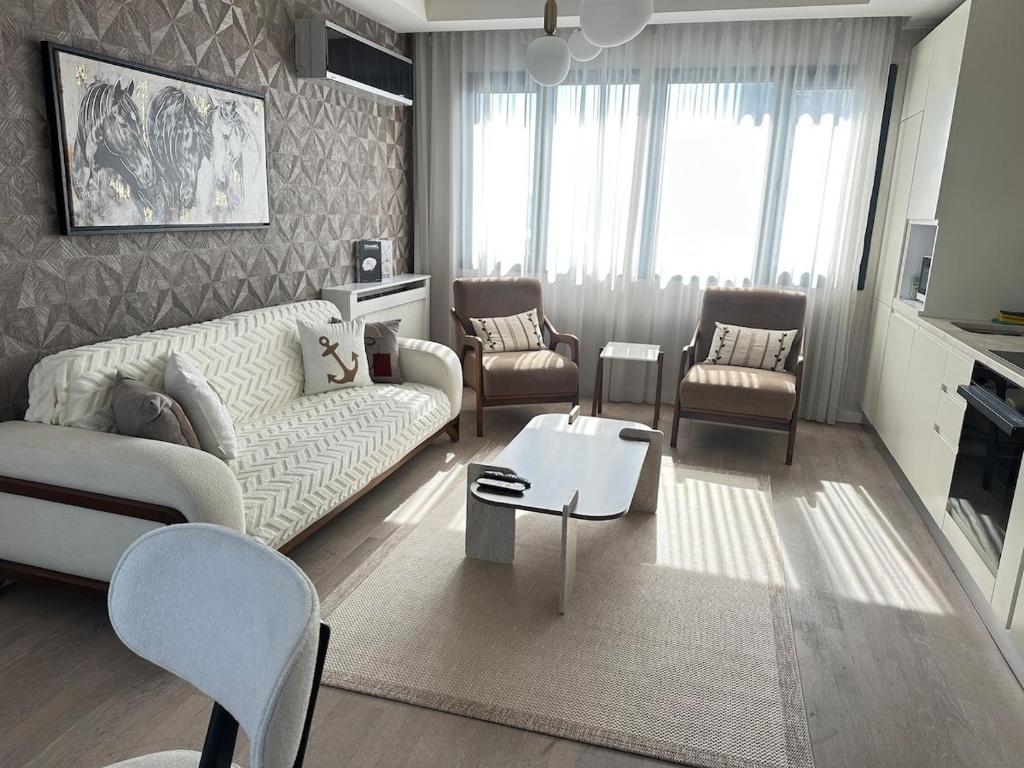 a living room with a couch and chairs and a table at 91 sqm luxury apartment with double view in Istanbul