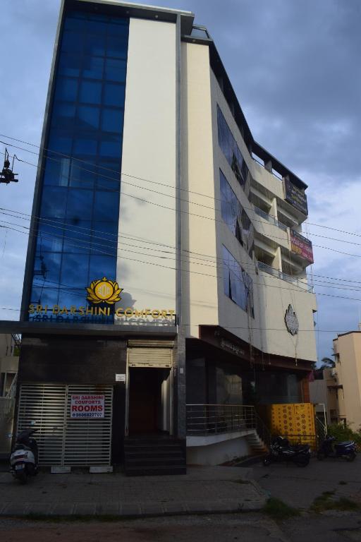 a building with a clock on the side of it at Sri Darshini Comfort 2kms from Hinkal Flyover in Mysore
