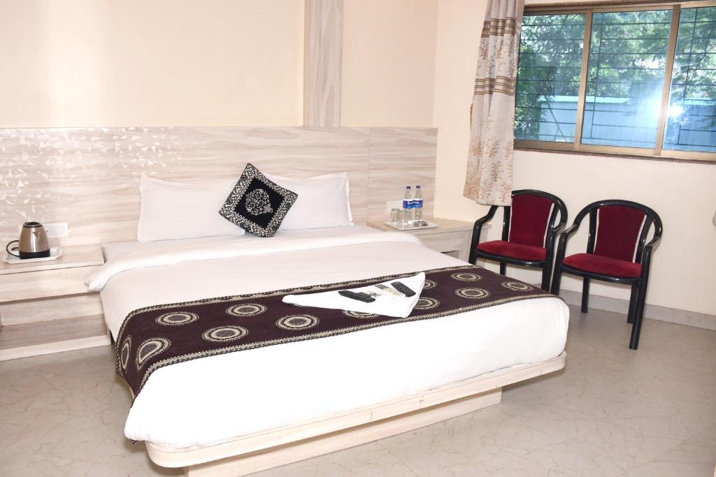 Ένα ή περισσότερα κρεβάτια σε δωμάτιο στο Kiwi International,Hotel,Mumbai