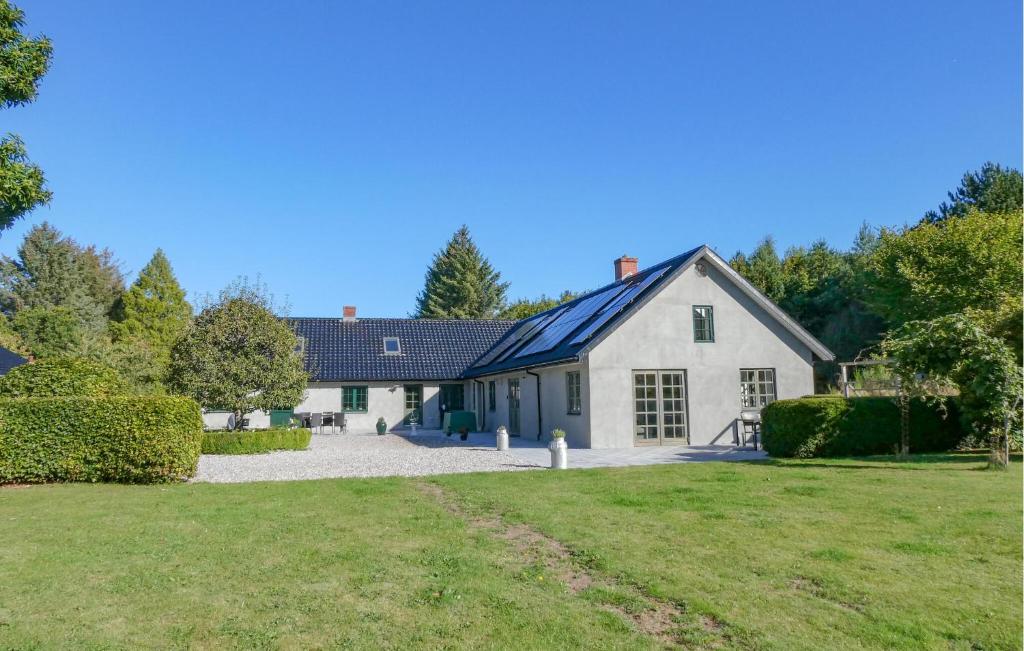 a large white house with a yard at Lovely Apartment In Glesborg With Wifi in Glesborg