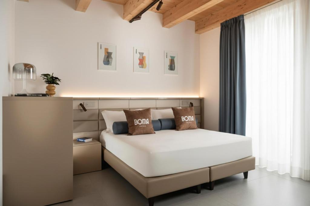 een slaapkamer met een wit bed en een raam bij BOMA Prime Rooms in Civitanova Marche
