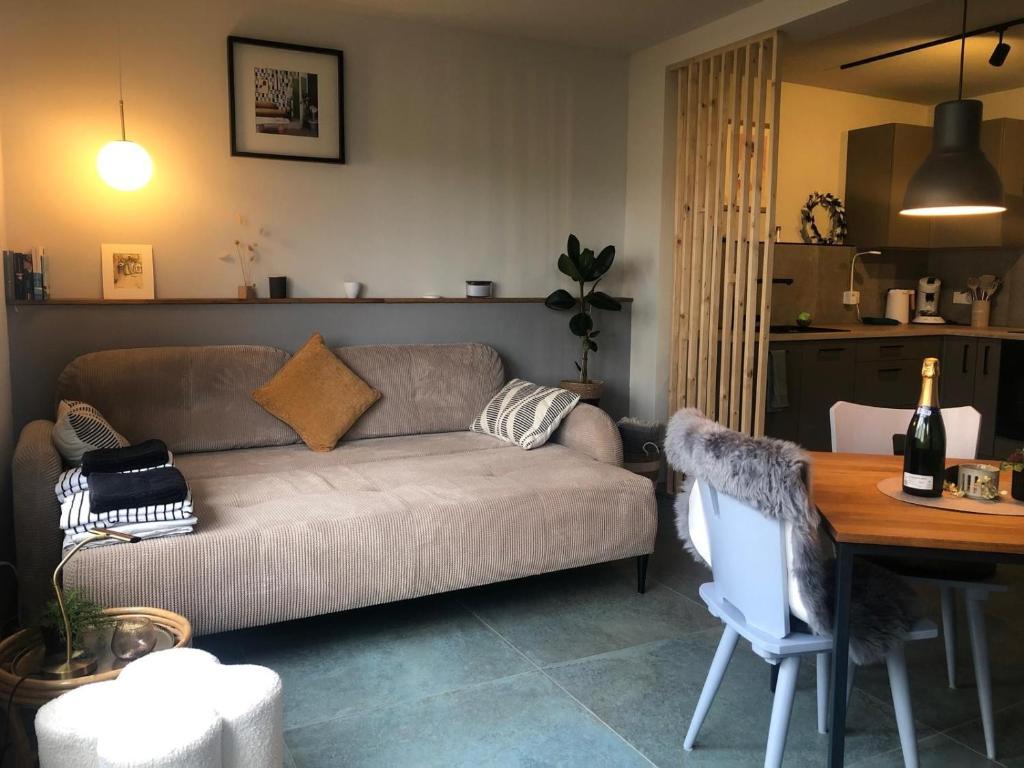 a living room with a couch and a table at das moselquartier terlinden in Besch