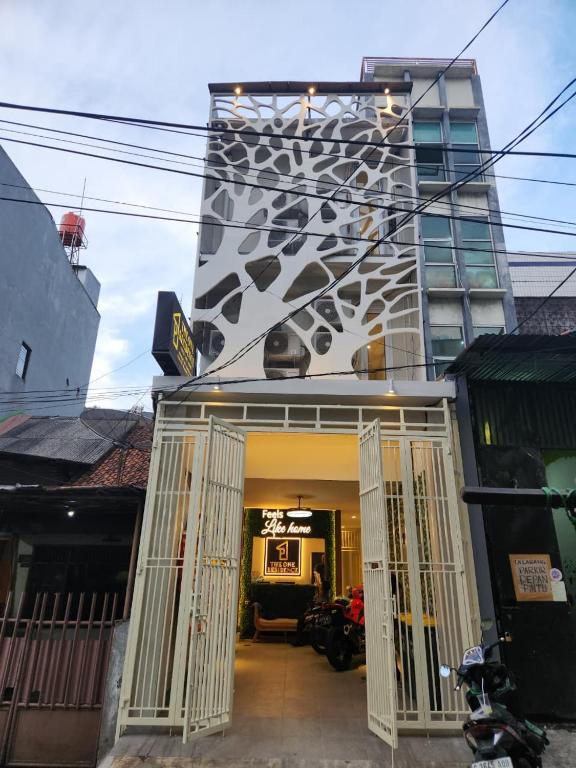 a building with a cow painted on the side of it at The One Residence Tanah Abang in Jakarta