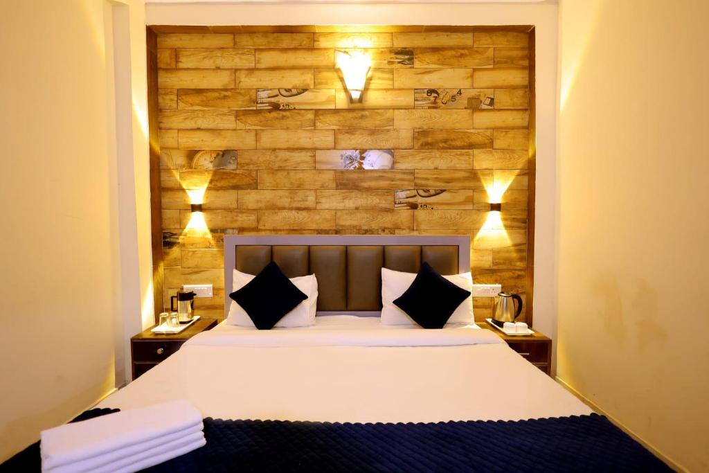 a bedroom with a large bed with two night stands at Hotel Basil Inn in Agra