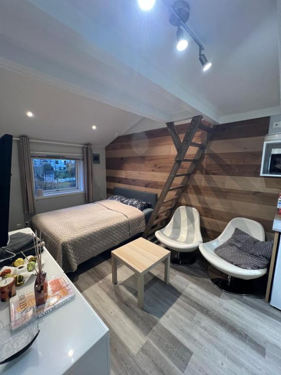 a bedroom with a bed and two chairs and a table at Sleep with the stars in Oslo
