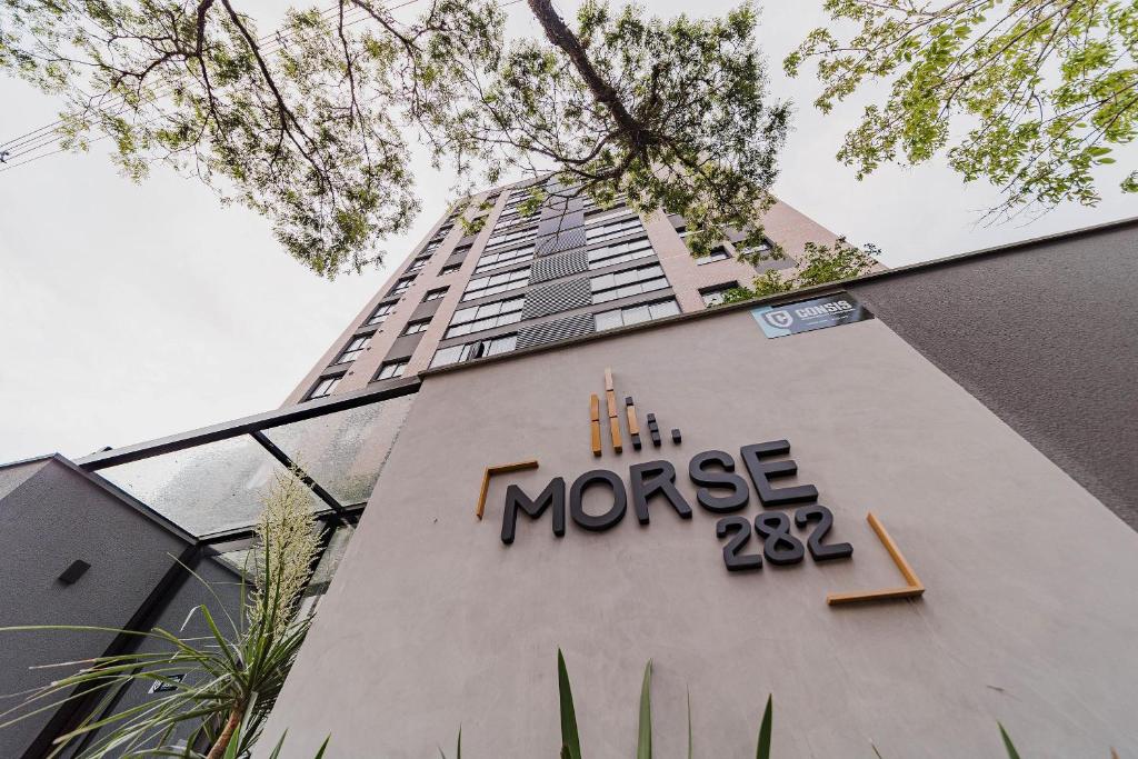 a building with a m mortgage sign in front of it at Morse Residencial Flipchave MOR000 in Joinville