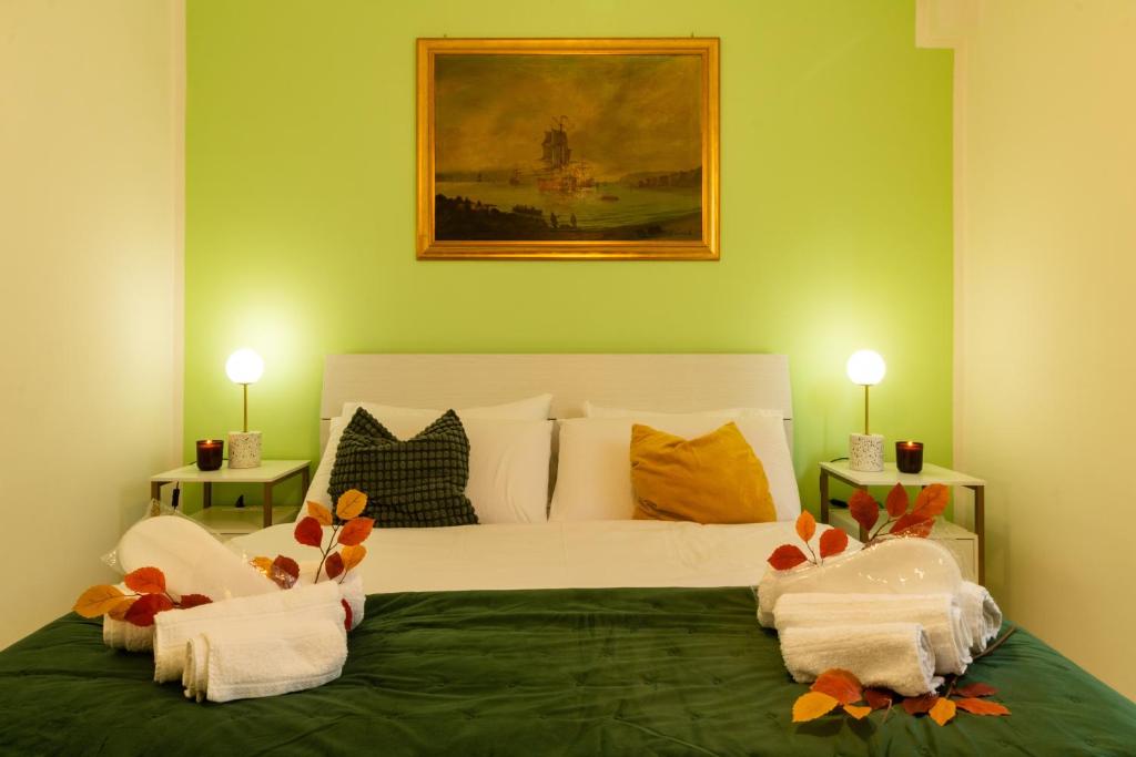 a bedroom with a large bed with towels on it at Casa Violante in Ancona