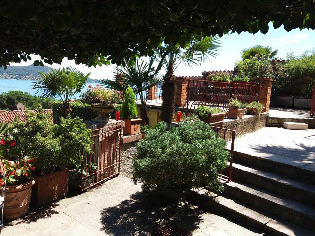 a garden with potted plants and a fence at Garden Apartment in Lesa