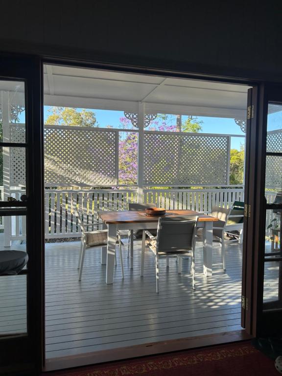 a patio with a table and chairs on a deck at Kinnoull in Brisbane