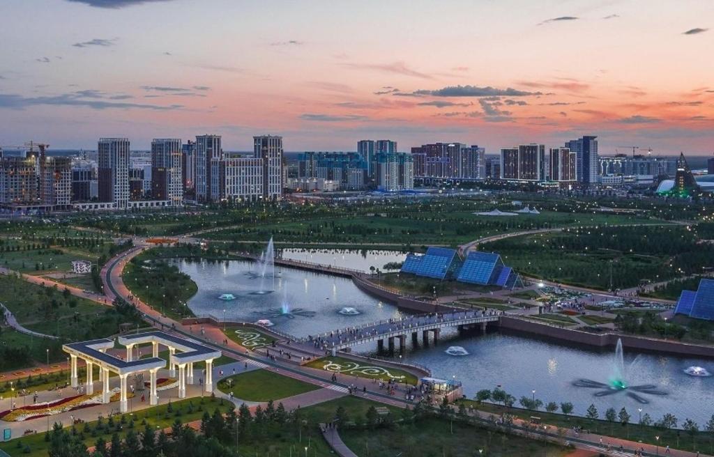 a view of a city with a river and buildings at Апартаменты рядом с Ботаническим садом, EXPO и Barys Arena in Astana