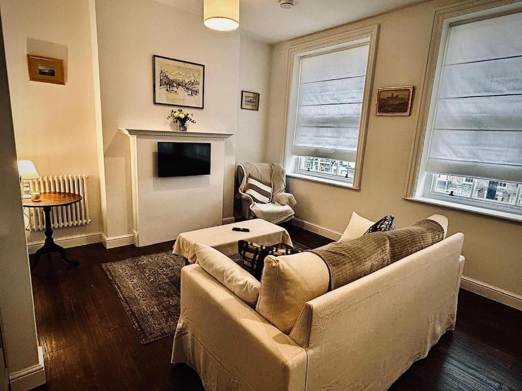 a living room with a couch and a fireplace at Clubhouse, North End, Bedale DL8 1AB in Bedale