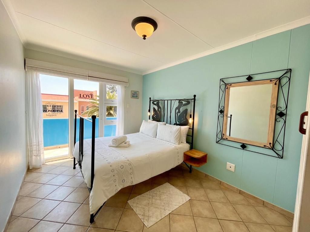 a bedroom with a bed and a mirror at Sealavie Central Apartment in Khomas Region