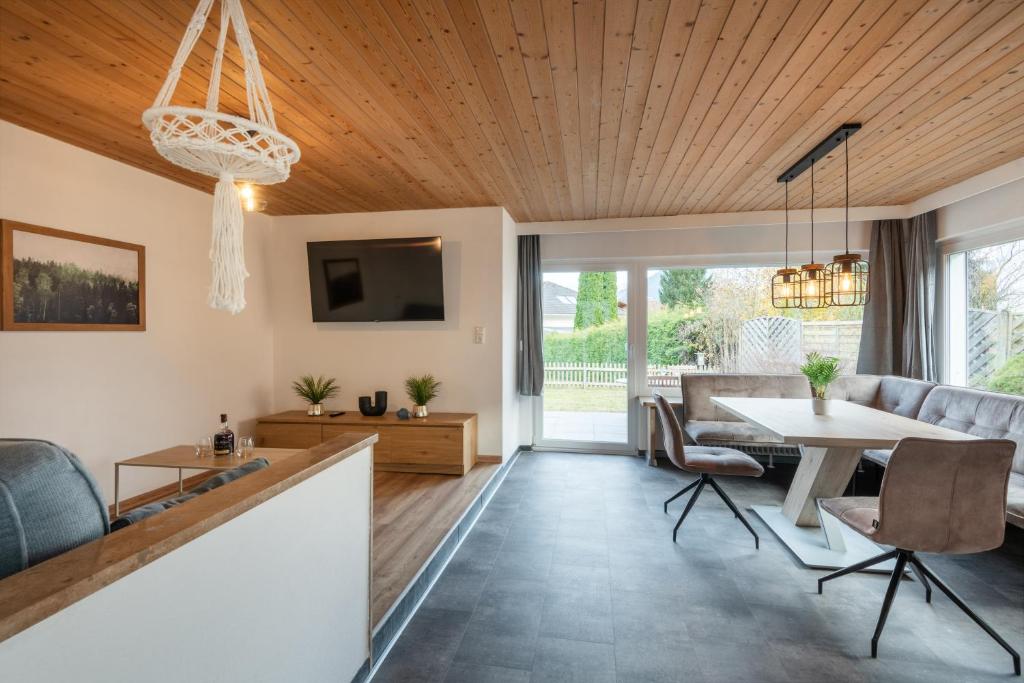 a living room with a table and a couch at Ferienhaus Gehrenblick in Oberletzen