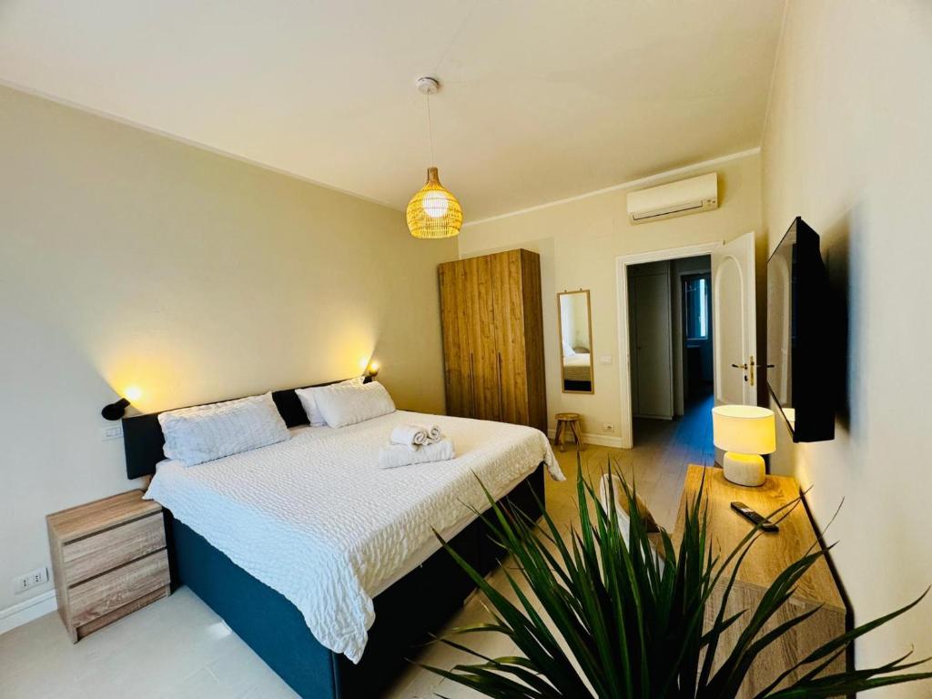 a bedroom with a bed and a potted plant at Borgo Pio Suite Apartment in Rome