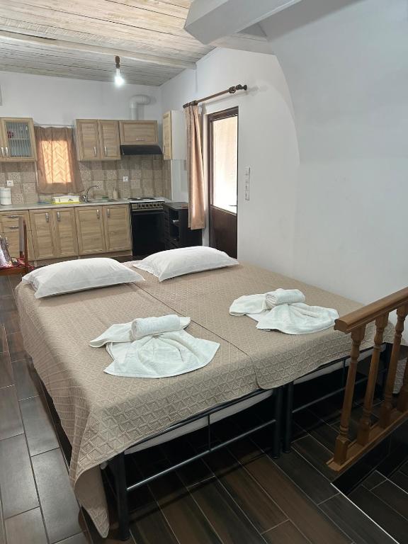 a large bed in a room with towels on it at Eleonoras House in Leonidio