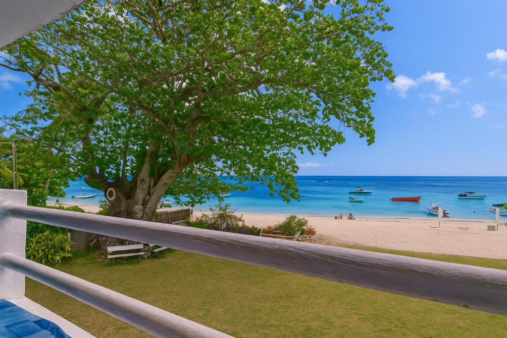 a view of the beach from the balcony of a house at Serge's Beachfront by Serenity in Trou aux Biches