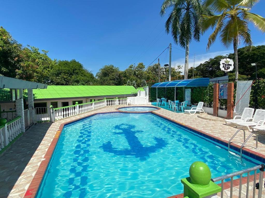 a swimming pool with a green ball in the water at hotel tocaima plaza in Tocaima