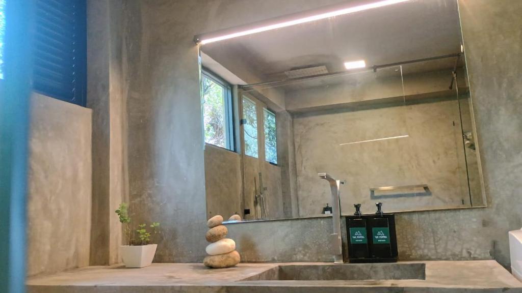 a bathroom with a sink and a large mirror at The Portal Manigala in Matale