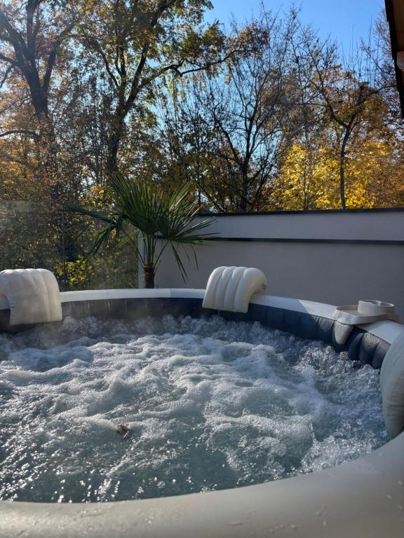 a jacuzzi tub with chairs in a backyard at Aix-les-Bains T3 haut standing écrin de calme avec jacuzzi en supplément in Saint-Simon