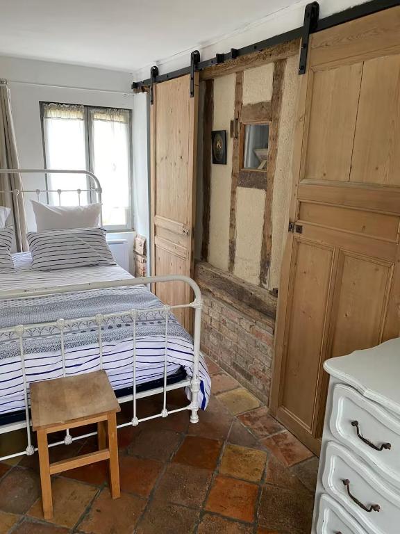a bedroom with a bed and a chair in it at Chambre privée autonome in Ouilly-du-Houley