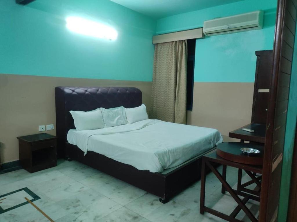 a bedroom with a bed and a television in it at Hotel Blue Bird in Jaipur