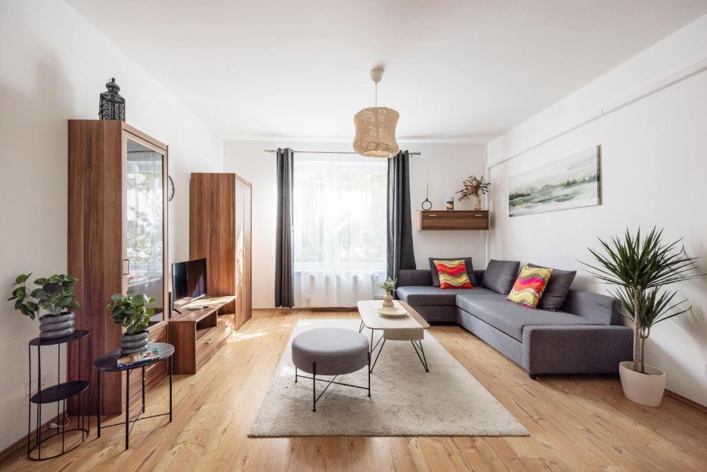 a living room with a couch and a table at Stylish City Stay in Budapest