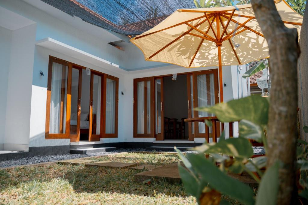 a house with an umbrella in front of it at Padma Graha Villa in Candidasa