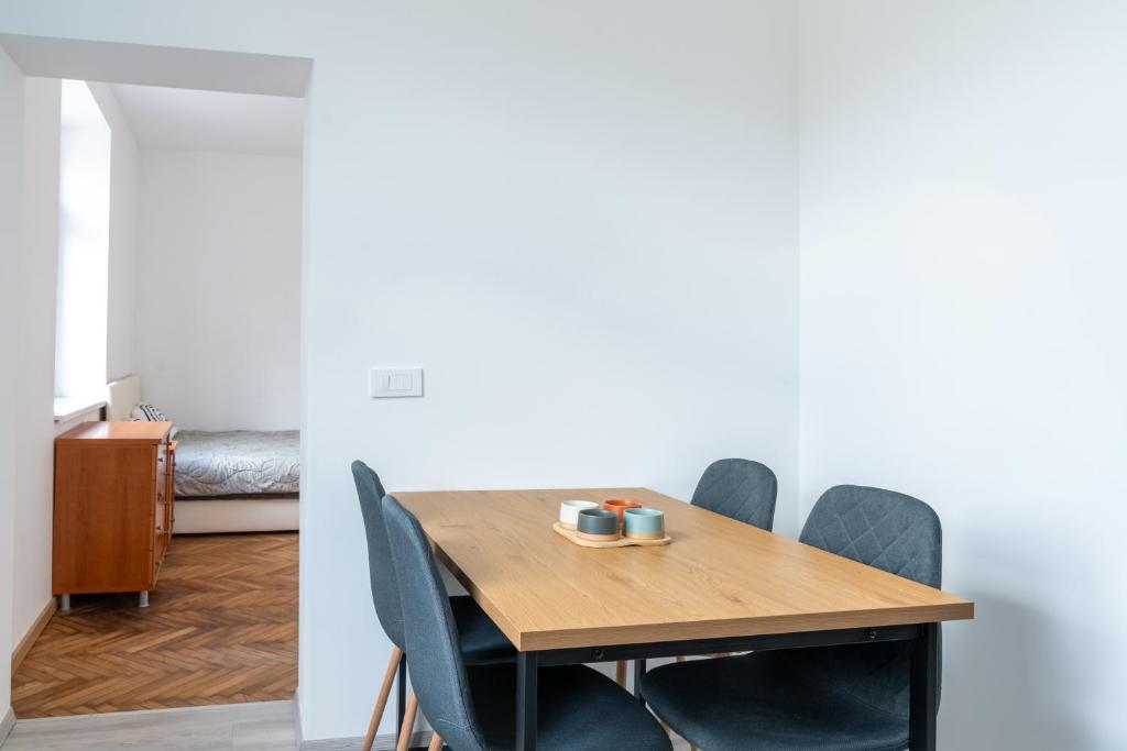 a dining room with a wooden table and chairs at Urban NEST apartment - FREE Parking & Central in Kočevje