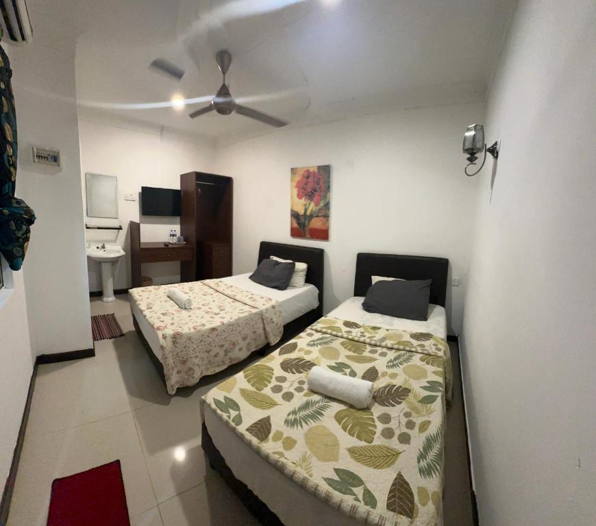 Postel nebo postele na pokoji v ubytování Forest Langkawi Stay Inn