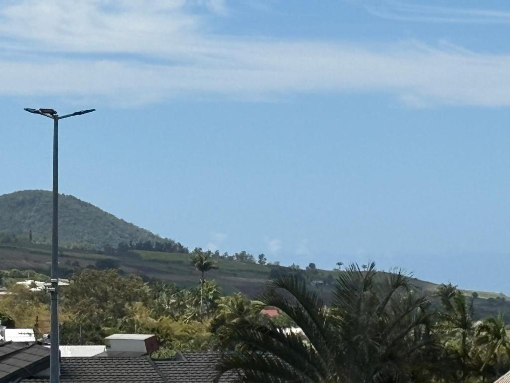 a view of a mountain with a street light at Coin de paradis in Le Tampon
