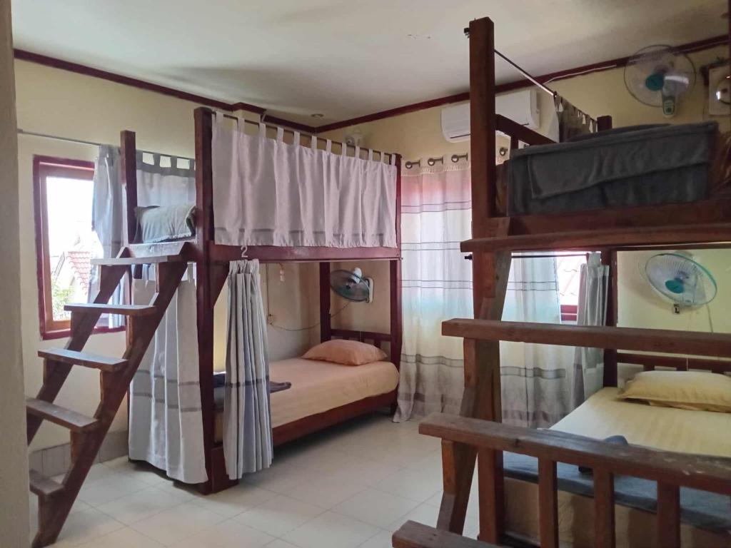 a bedroom with two bunk beds in a room at Ning Ning hostel Dondet in Don Det