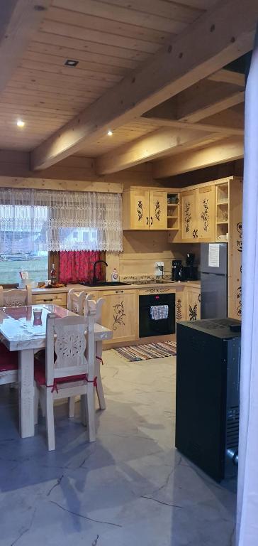 a kitchen with a table and chairs in a room at Bachledowy Wierch 2 in Czerwienne