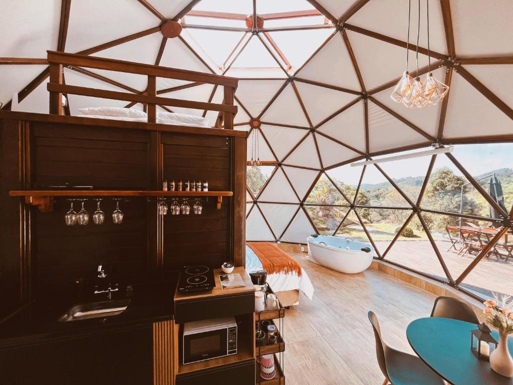 a room with a large glass dome with a tub at Skydomo in Salesópolis