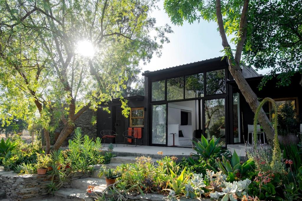 a house with glass doors and a garden at Aarde in Barrydale