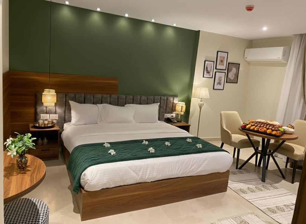 a bedroom with a large bed with a green wall at Boutique De Pirámides Nómadas in Cairo