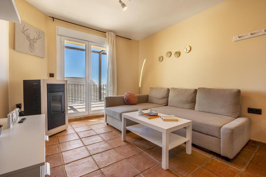 a living room with a couch and a table at Alpine Sierra Nevada in Sierra Nevada