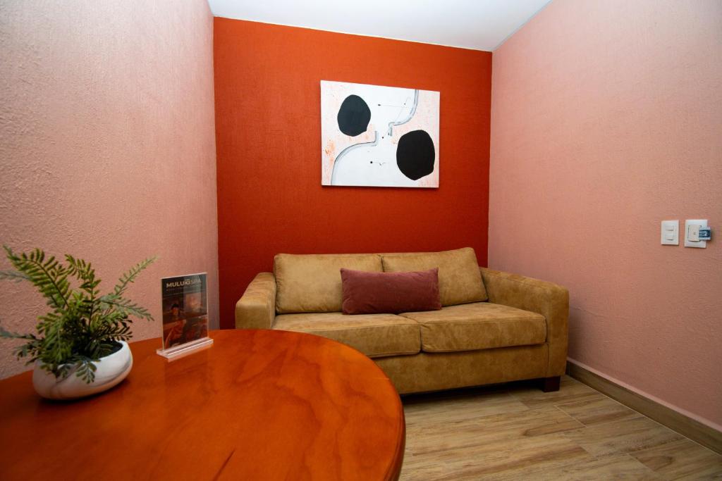 a living room with a couch and a table at Hotel Suites Corazón Mexicano in Guanajuato