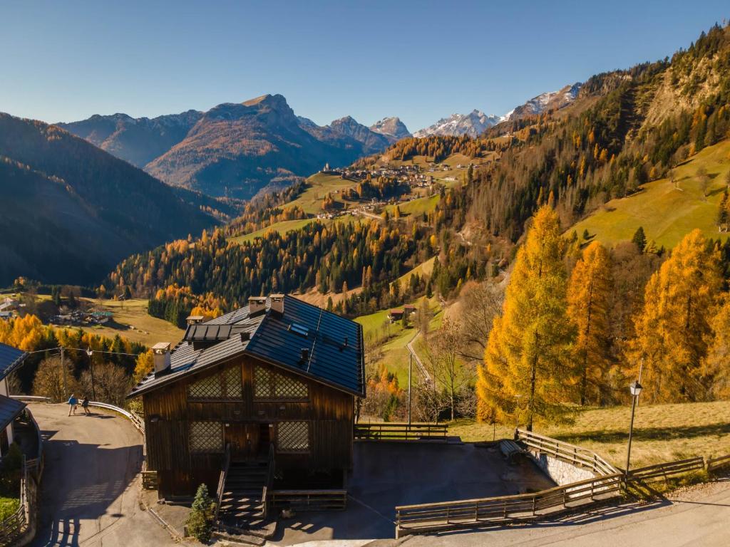 a building with a view of a mountain at Dreamful Cottage in Selva di Cadore
