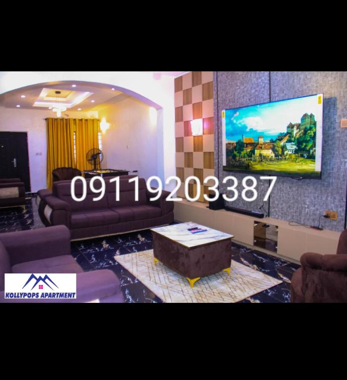 a living room with a couch and a coffee table at KOLLYPOPS Apartments in Otta