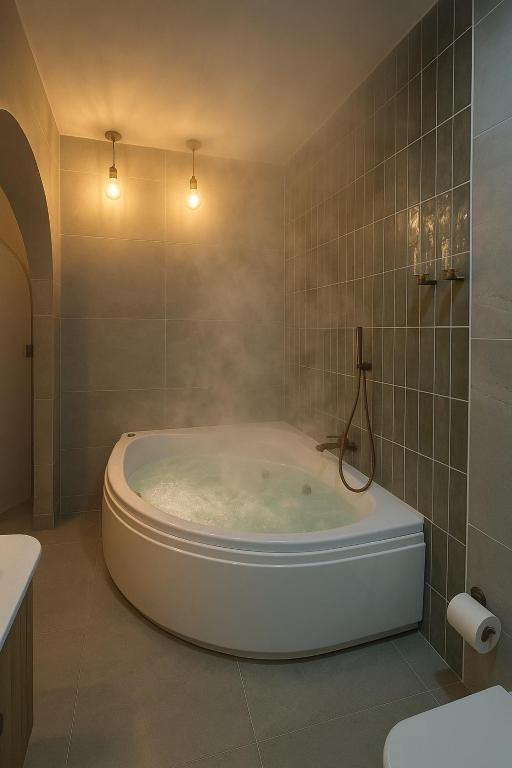 a bathroom with a large tub in a room at קציר ריזורט in Migdal
